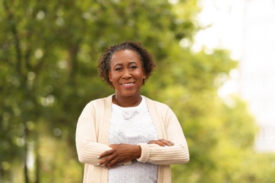 Photo of Portrait of happy African-American woman in park