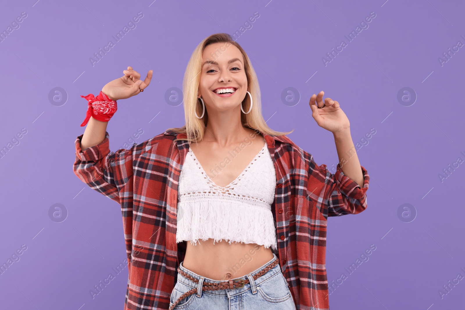 Photo of Portrait of happy hippie woman on purple background