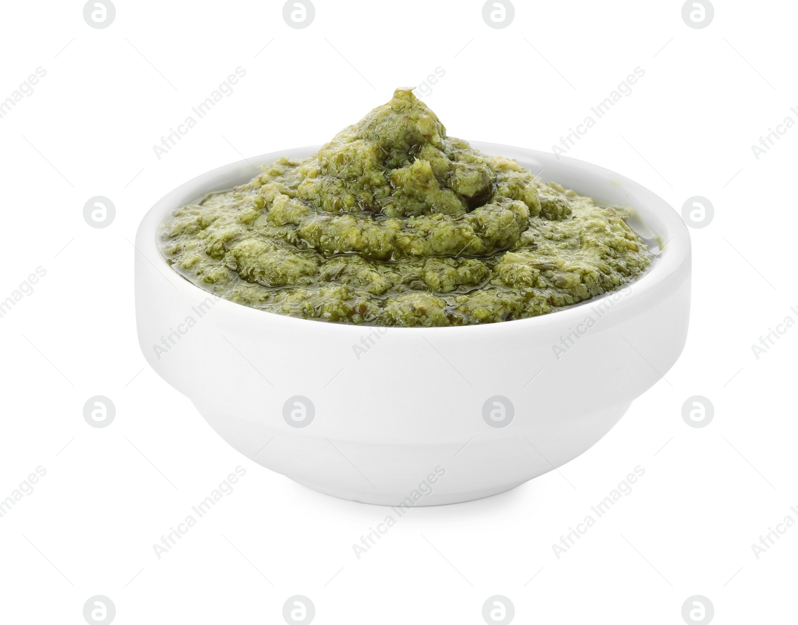 Photo of Tasty pesto sauce in bowl isolated on white