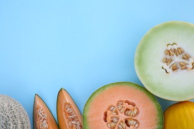 Photo of Different tasty ripe melons on turquoise background, flat lay. Space for text