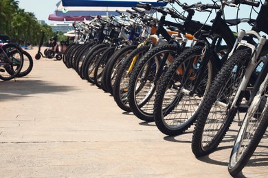 Photo of Parking with different bicycles outdoors on sunny day