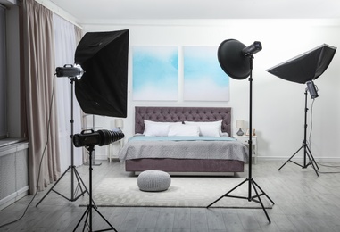Photo of Professional photo studio equipment prepared for shooting bedroom interior