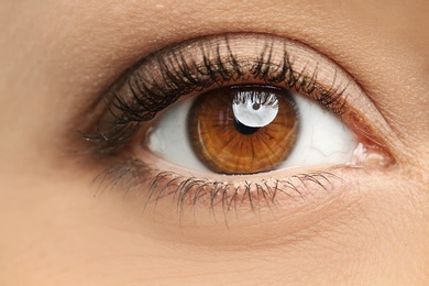 Photo of Young woman, closeup of eye. Visiting ophthalmologist
