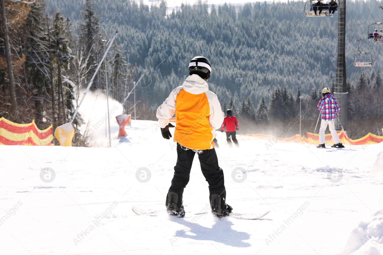 Photo of People skiing on snowy hill in mountains. Winter vacation