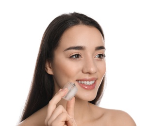 Photo of Young woman with ice cube on white background. Skin care