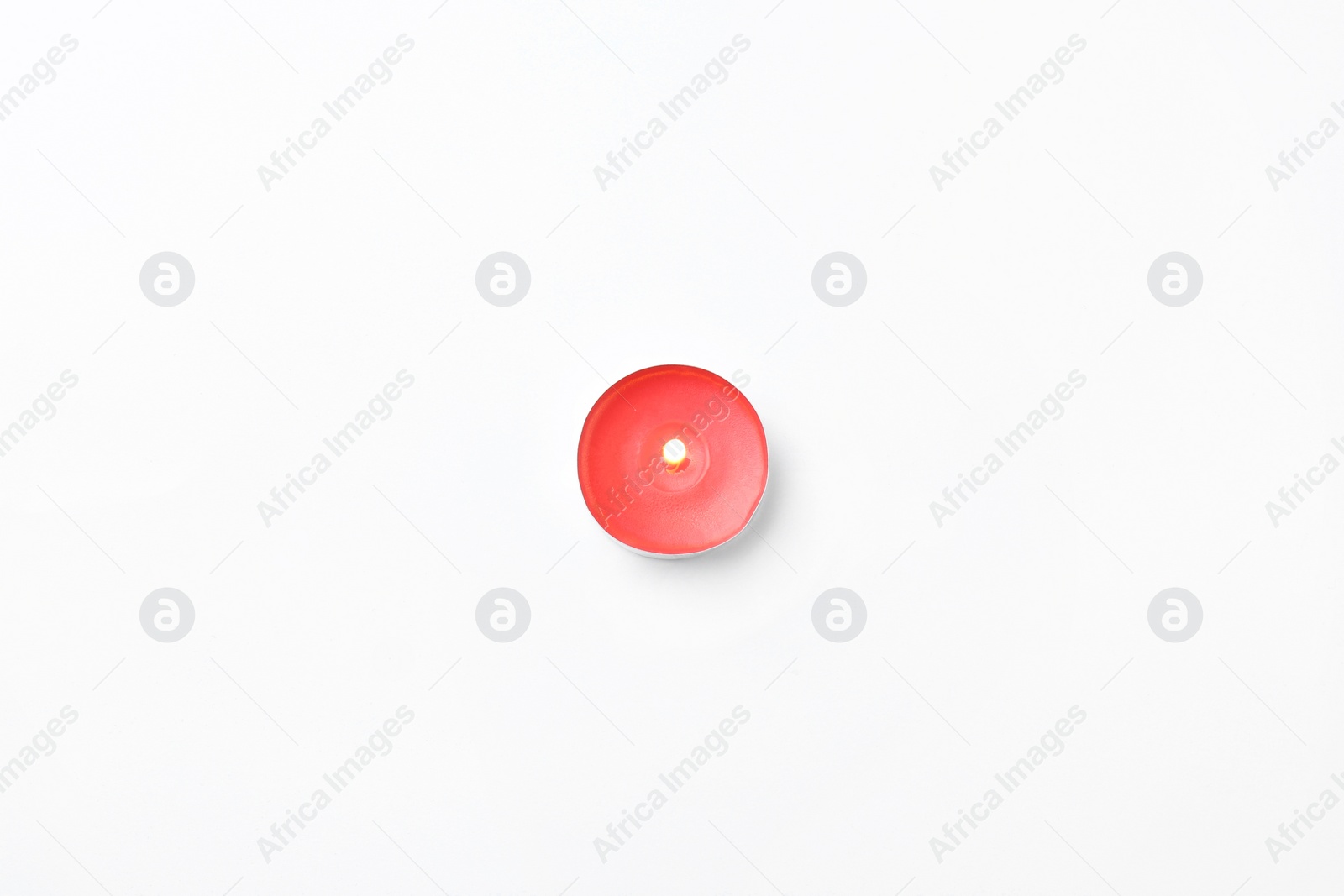 Photo of Red small candle isolated on white, top view