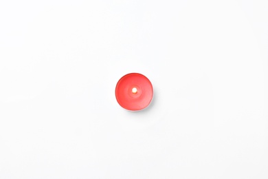 Red small candle isolated on white, top view