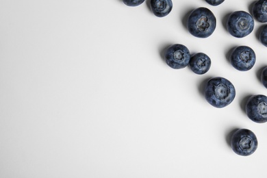 Tasty ripe blueberries on white background, flat lay