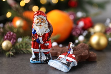 Chocolate Santa Claus candies on grey table