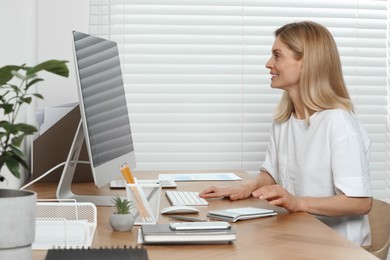 Professional accountant working at wooden desk in office