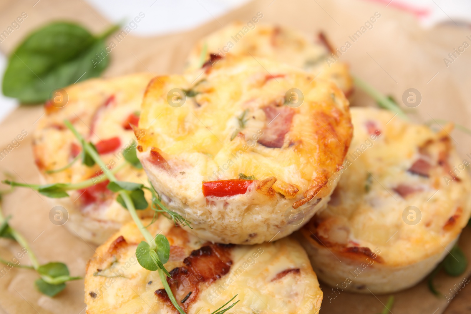 Photo of Delicious egg muffins with cheese and bacon on table, closeup