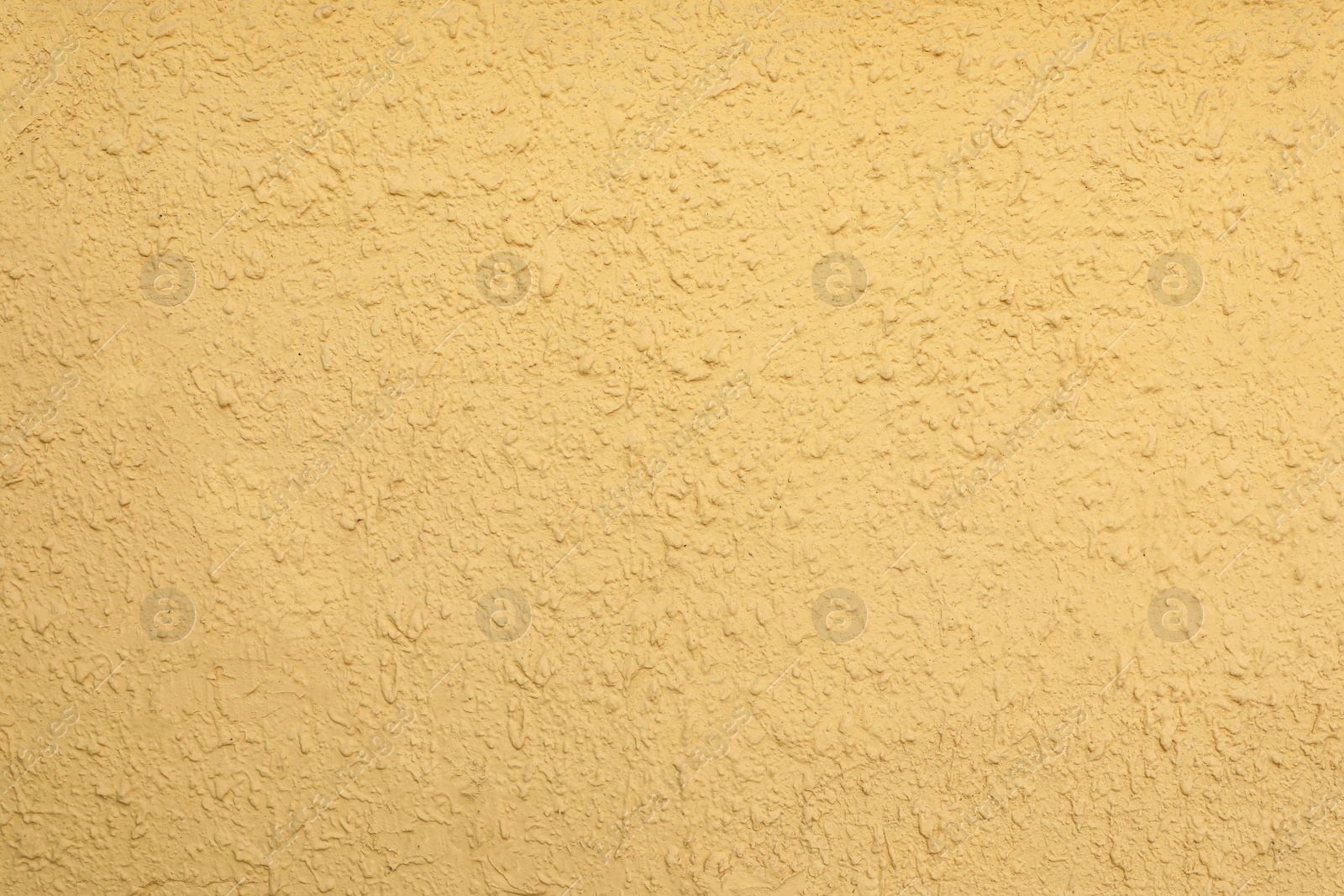 Photo of Texture of yellow plaster wall as background