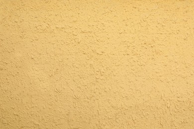 Texture of yellow plaster wall as background