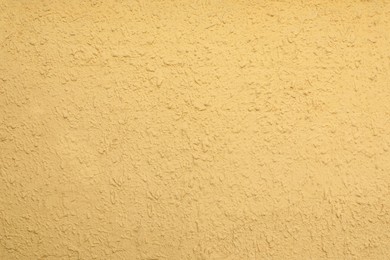 Photo of Texture of yellow plaster wall as background