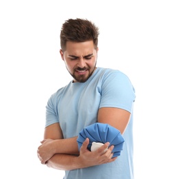 Photo of Young man with cold compress suffering from elbow pain on white background