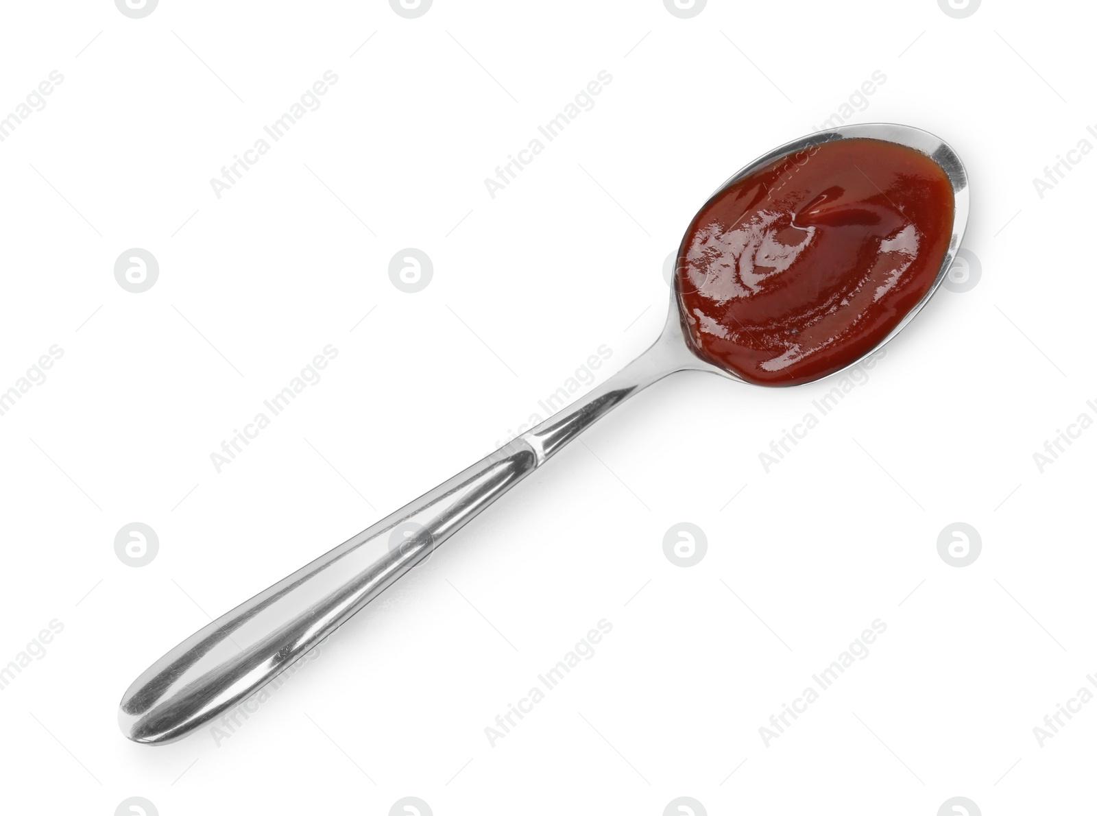 Photo of Tasty barbecue sauce in spoon isolated on white, top view