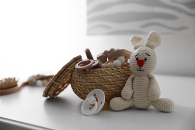 Photo of Baby accessories and toys on table in room