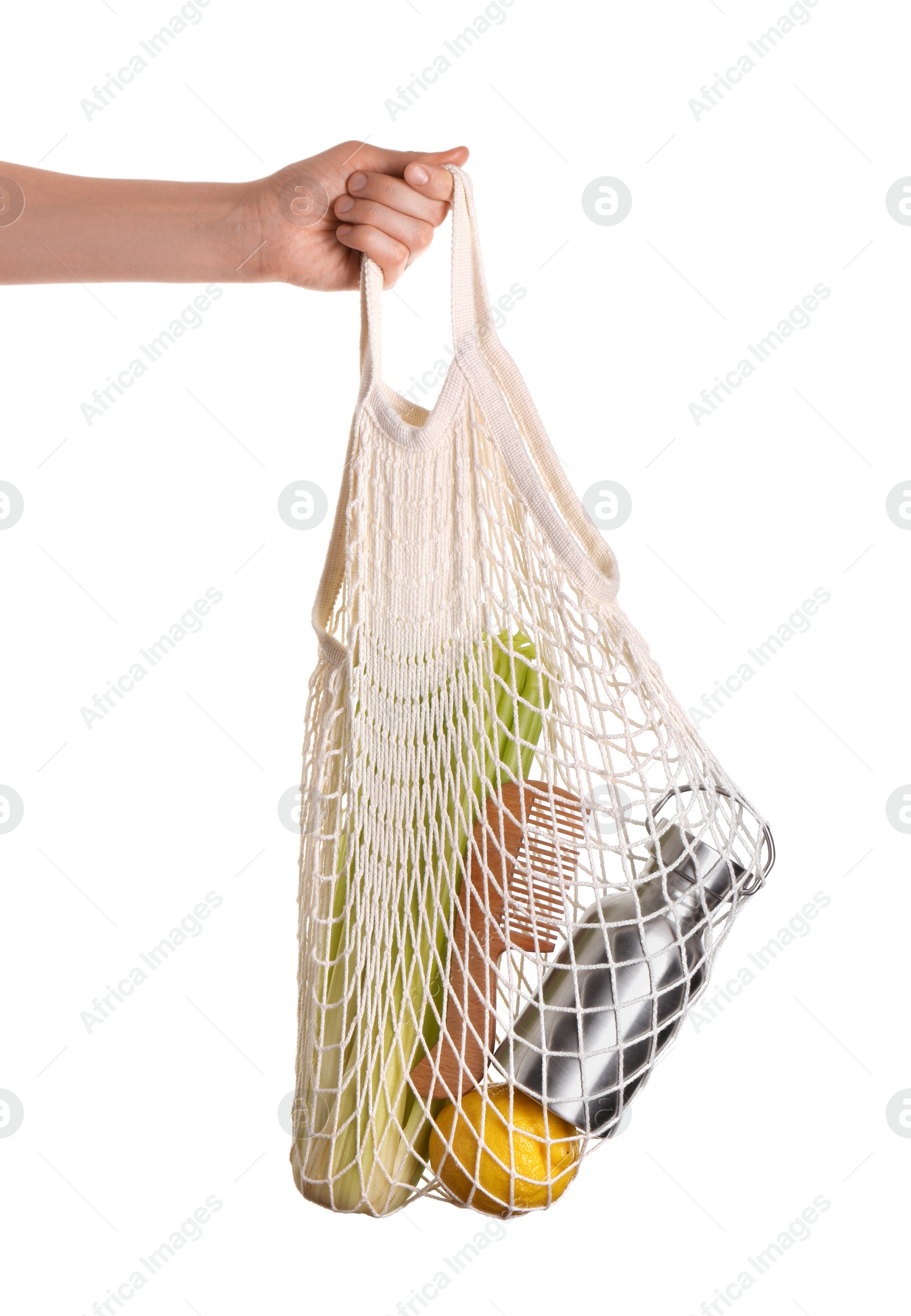 Photo of Woman holding net bag with different items on white background, closeup. Conscious consumption