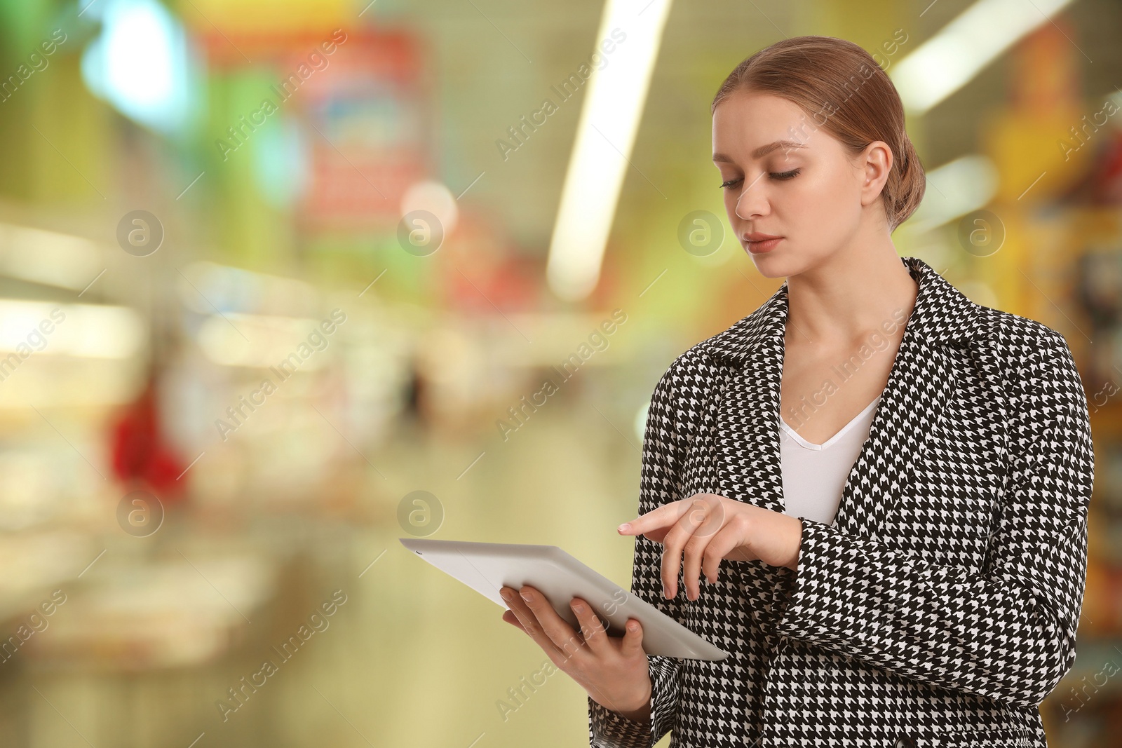 Image of Inspector with tablet in shopping mall, space for text. Quality control