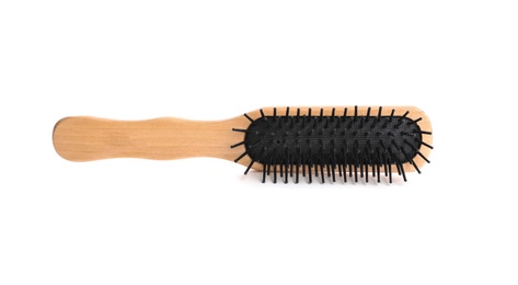 Photo of New wooden hair brush on white background