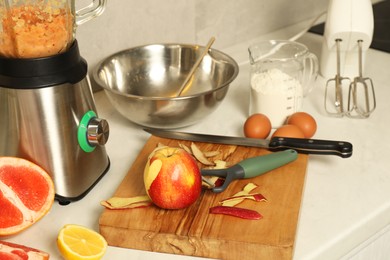 Photo of Modern mixer, blender and different ingredients on white marble countertop