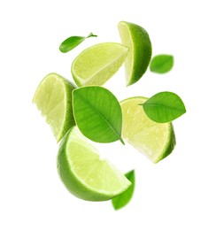 Image of Fresh lime slices and green leaves falling on white background