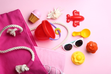 Photo of Flat lay composition with bright beach toys on color background