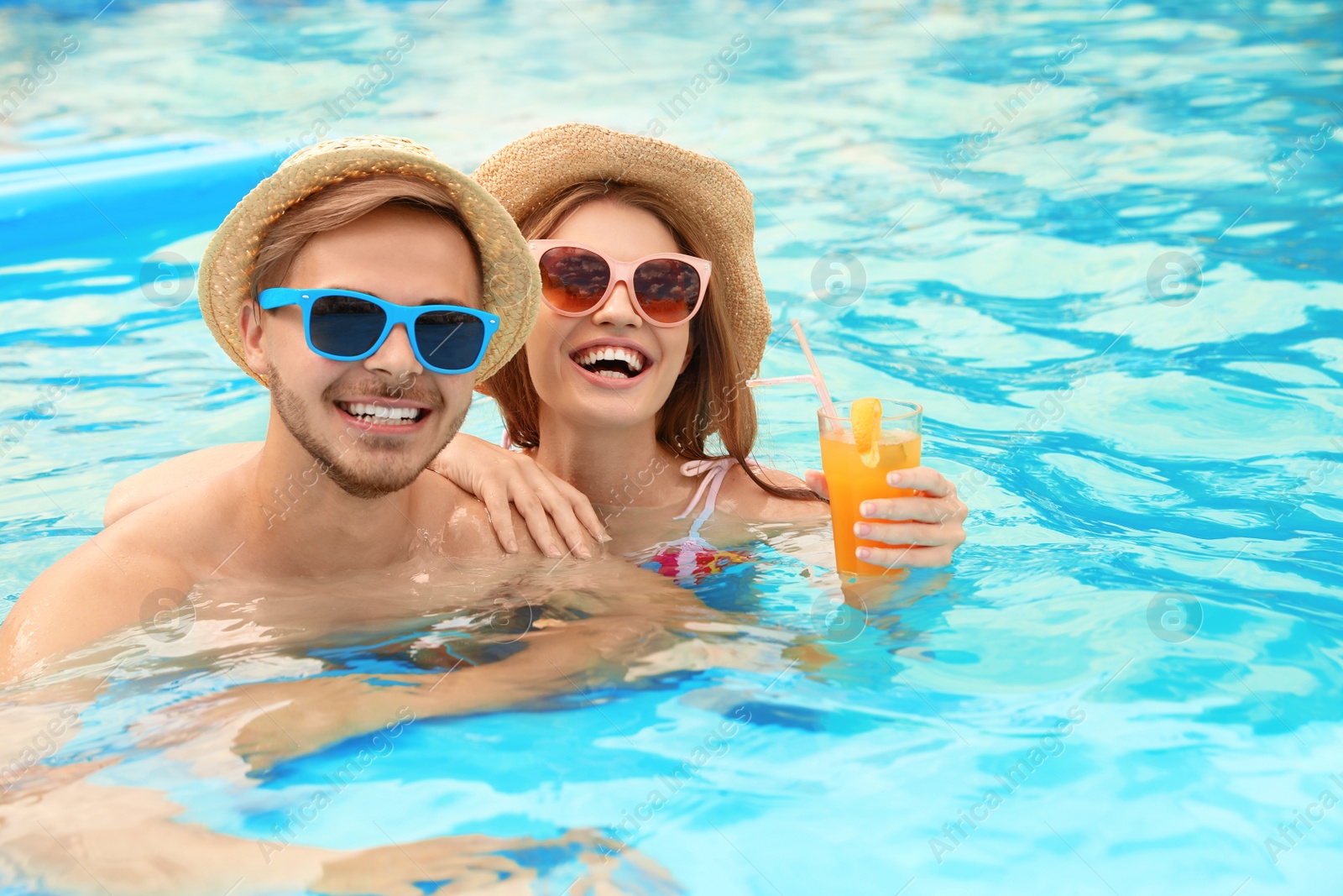 Photo of Young couple in pool on sunny day