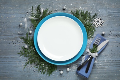 Photo of Beautiful Christmas table setting on grey wooden background, flat lay