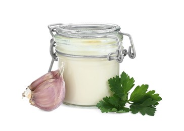 Photo of Fresh mayonnaise sauce in glass jar, garlic and parsley isolated on white