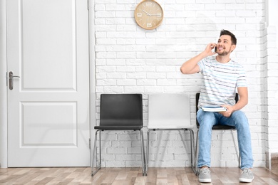 Photo of Young man waiting for job interview, indoors