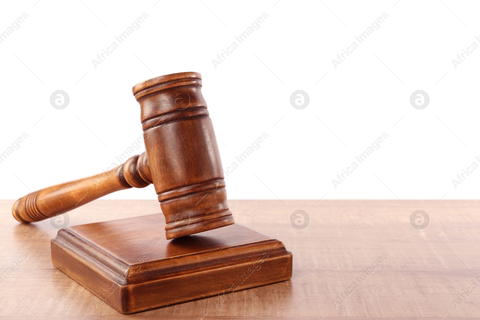 Photo of Gavel on wooden table against white background, space for text. Small mallet