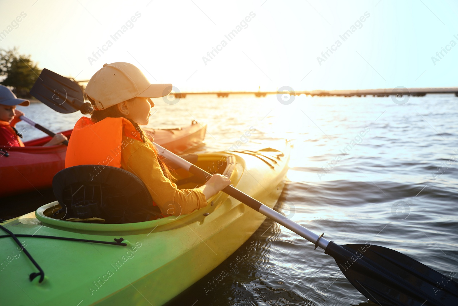 Photo of Little children kayaking on river. Summer camp activity