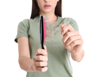Photo of Young woman with brush on white background, closeup. Hair loss problem