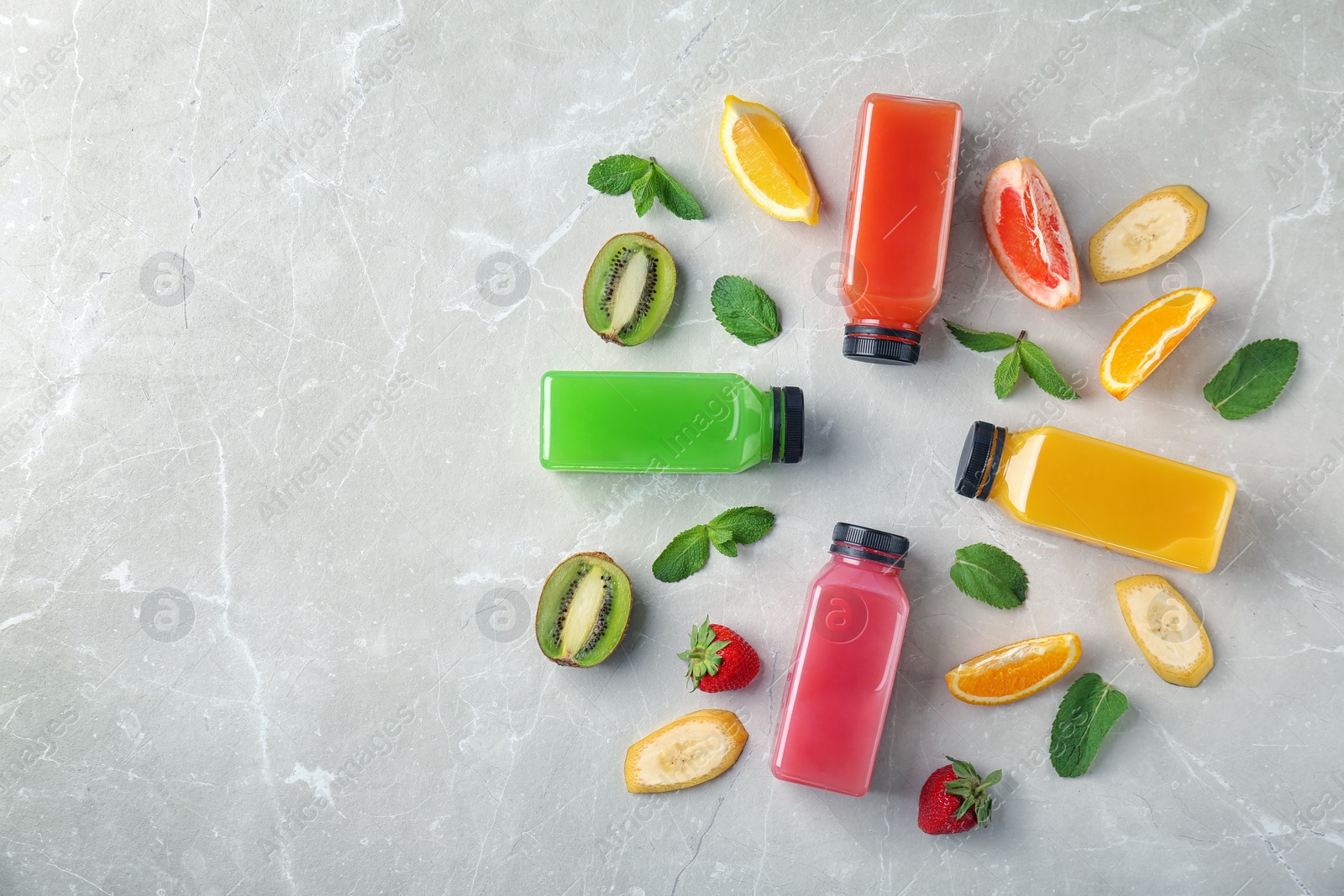 Photo of Flat lay composition with tasty juices and ingredients on light background