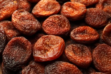 Tasty dried apricots as background, closeup. Healthy snack