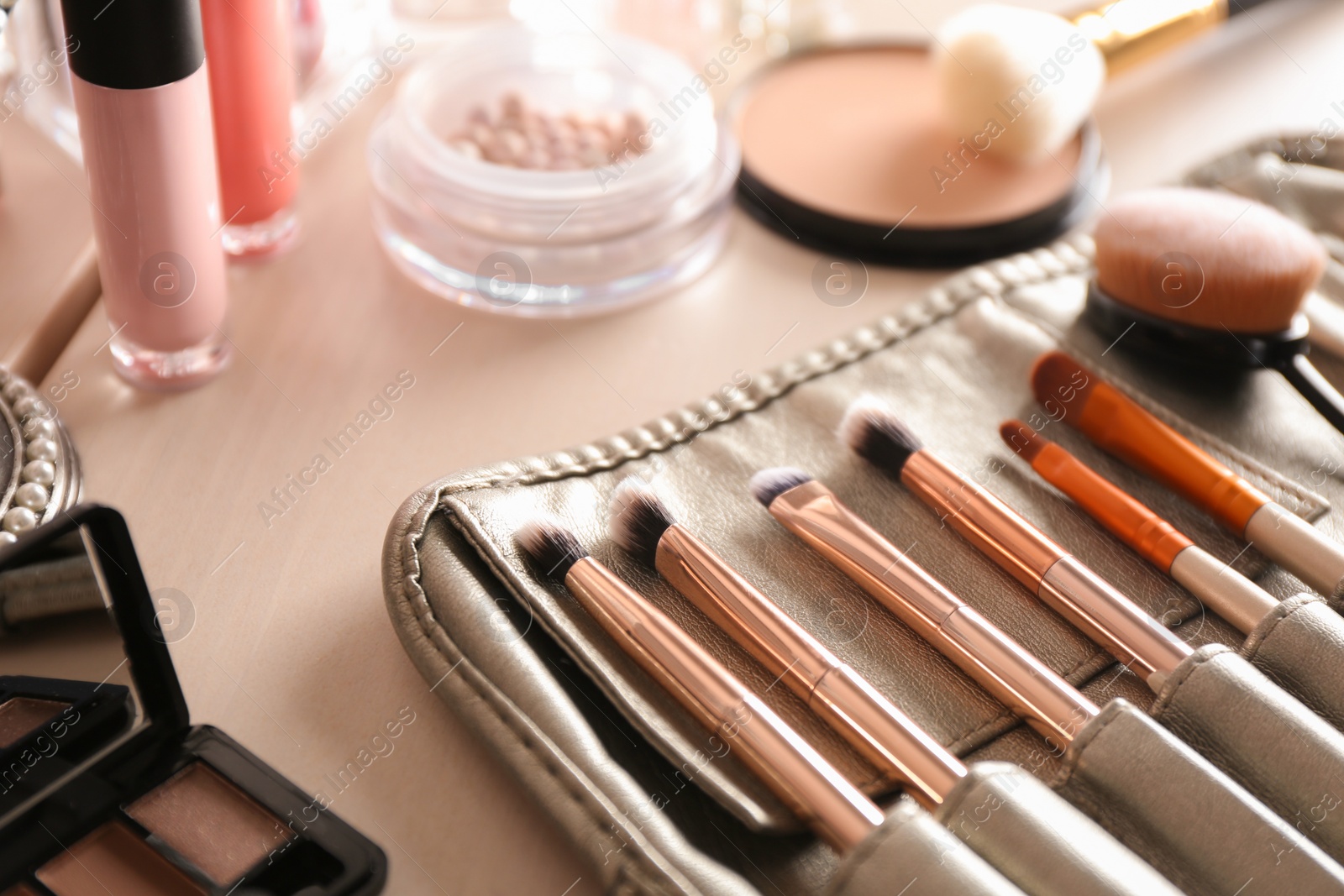 Photo of Luxury cosmetics and beauty accessories on dressing table