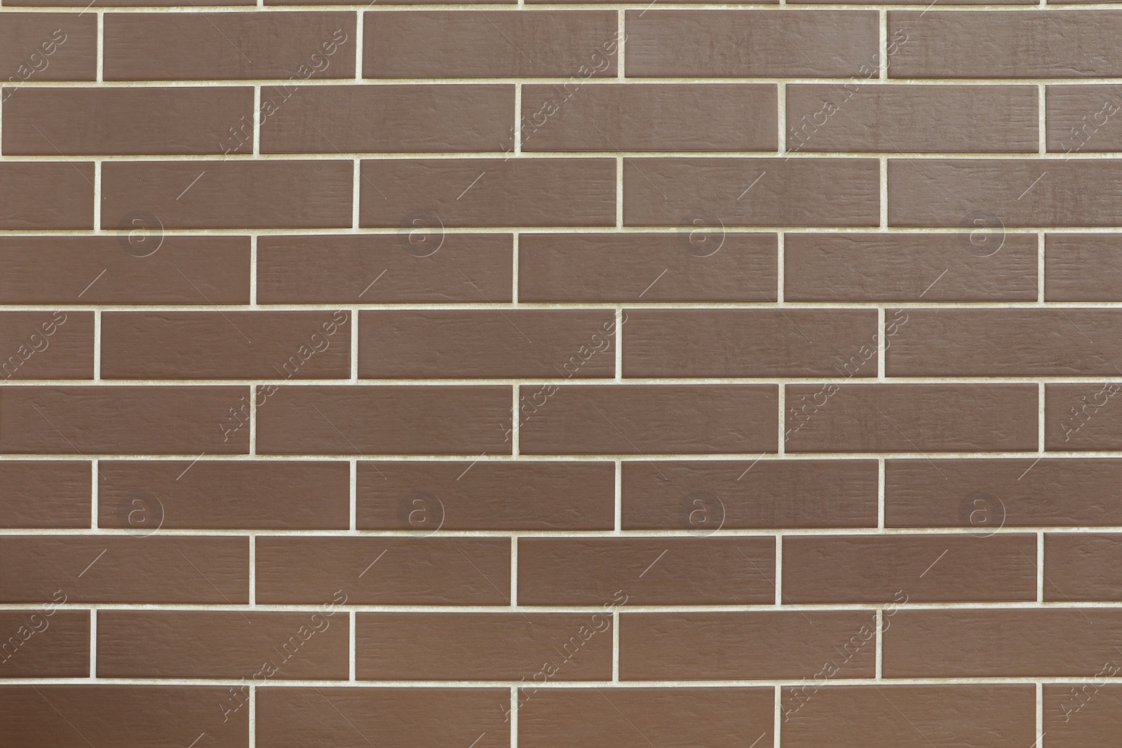 Photo of Texture of brown brick wall tiles as background