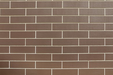 Photo of Texture of brown brick wall tiles as background