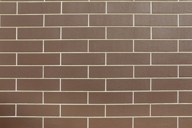 Texture of brown brick wall tiles as background