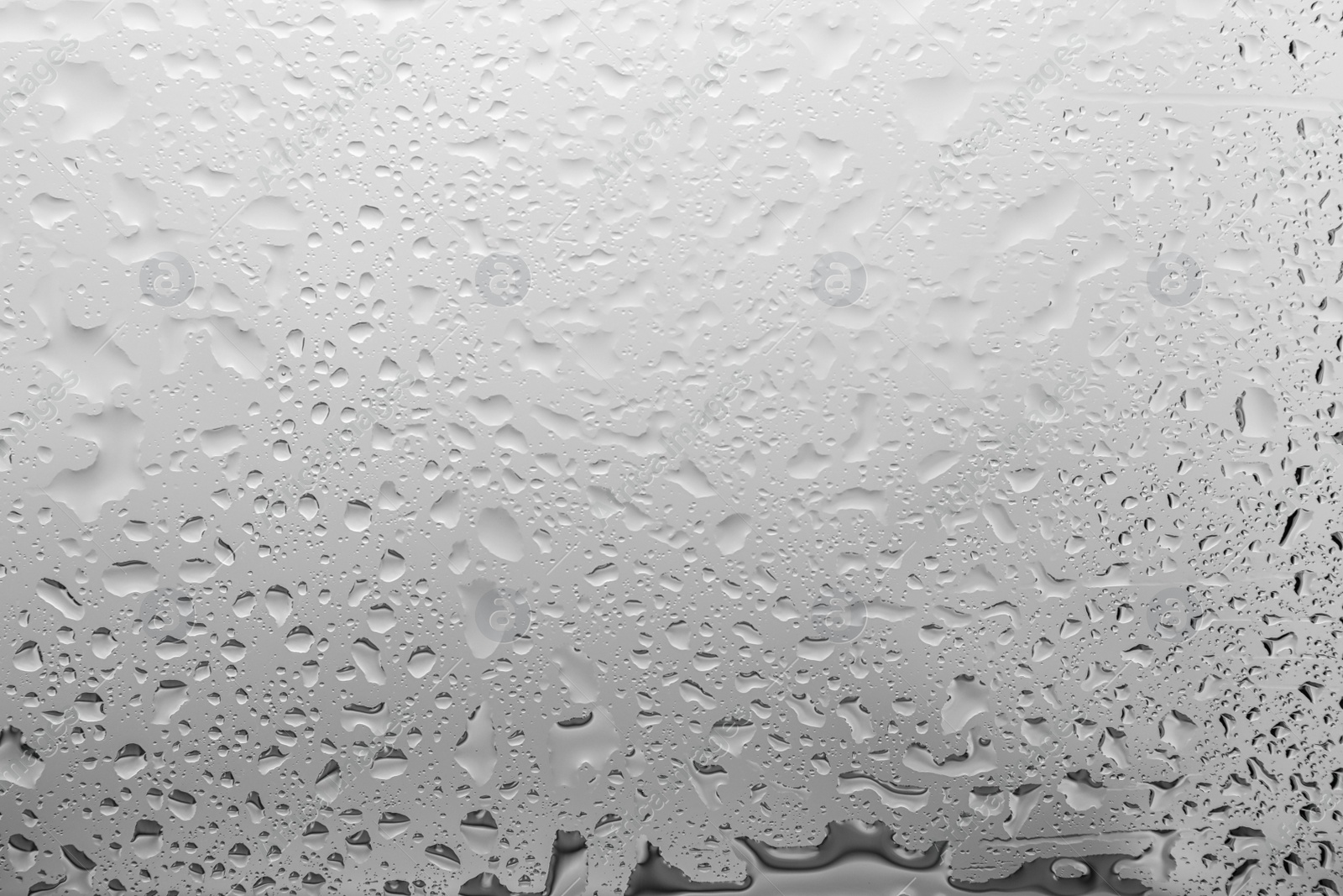 Photo of Water drops on light background, closeup view