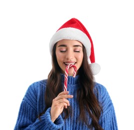 Beautiful woman in Santa Claus hat holding candy cane on white background
