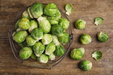 Fresh Brussels sprouts on wooden table, flat lay