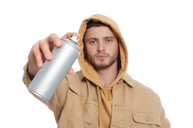 Handsome man holding can of spray paint on white background