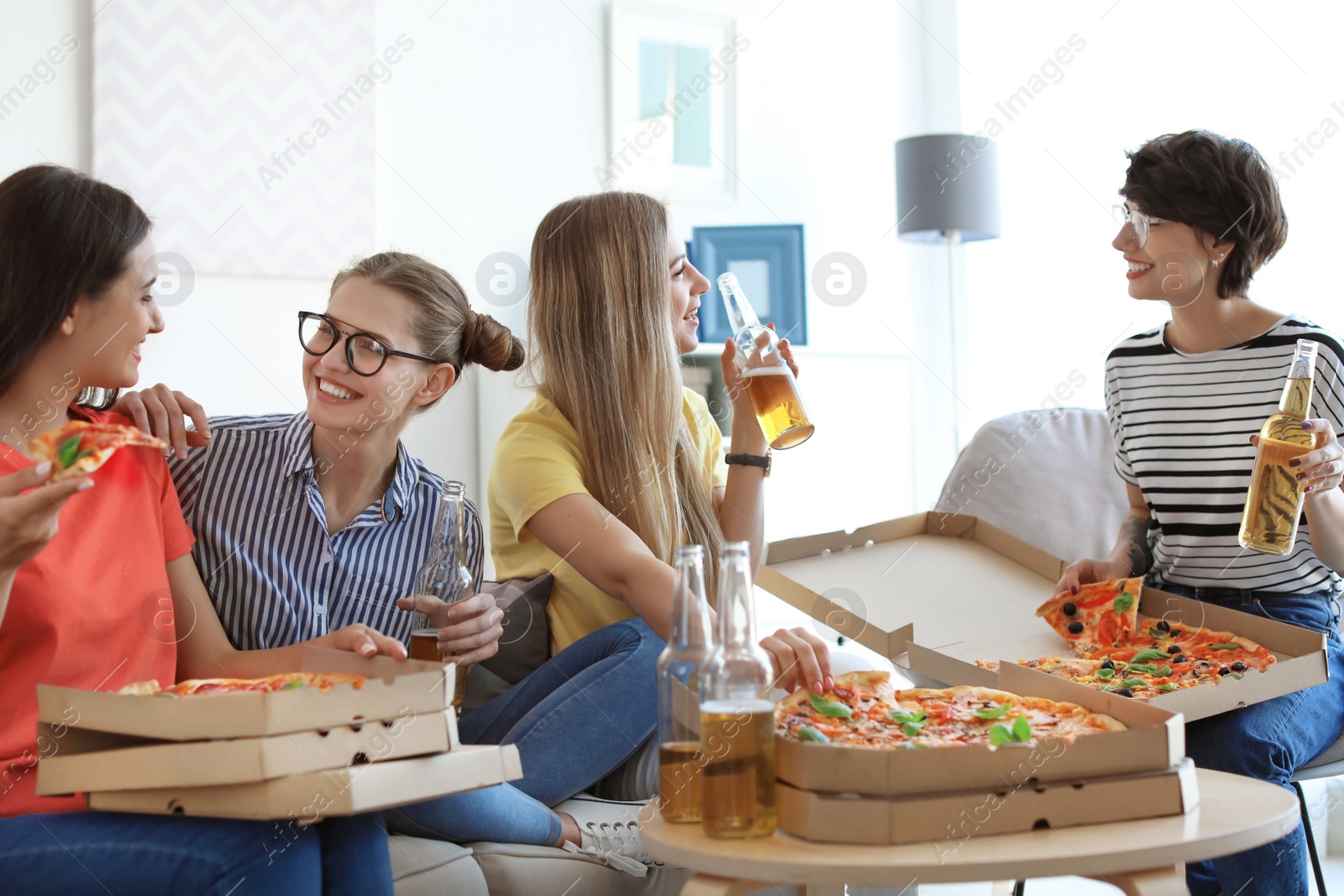 Photo of Young people having fun party with delicious pizza indoors