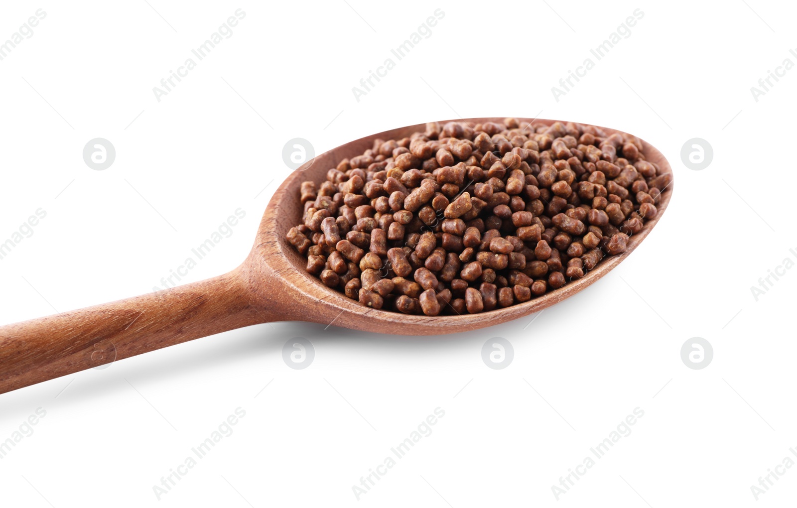 Photo of Wooden spoon with buckwheat tea granules on white background