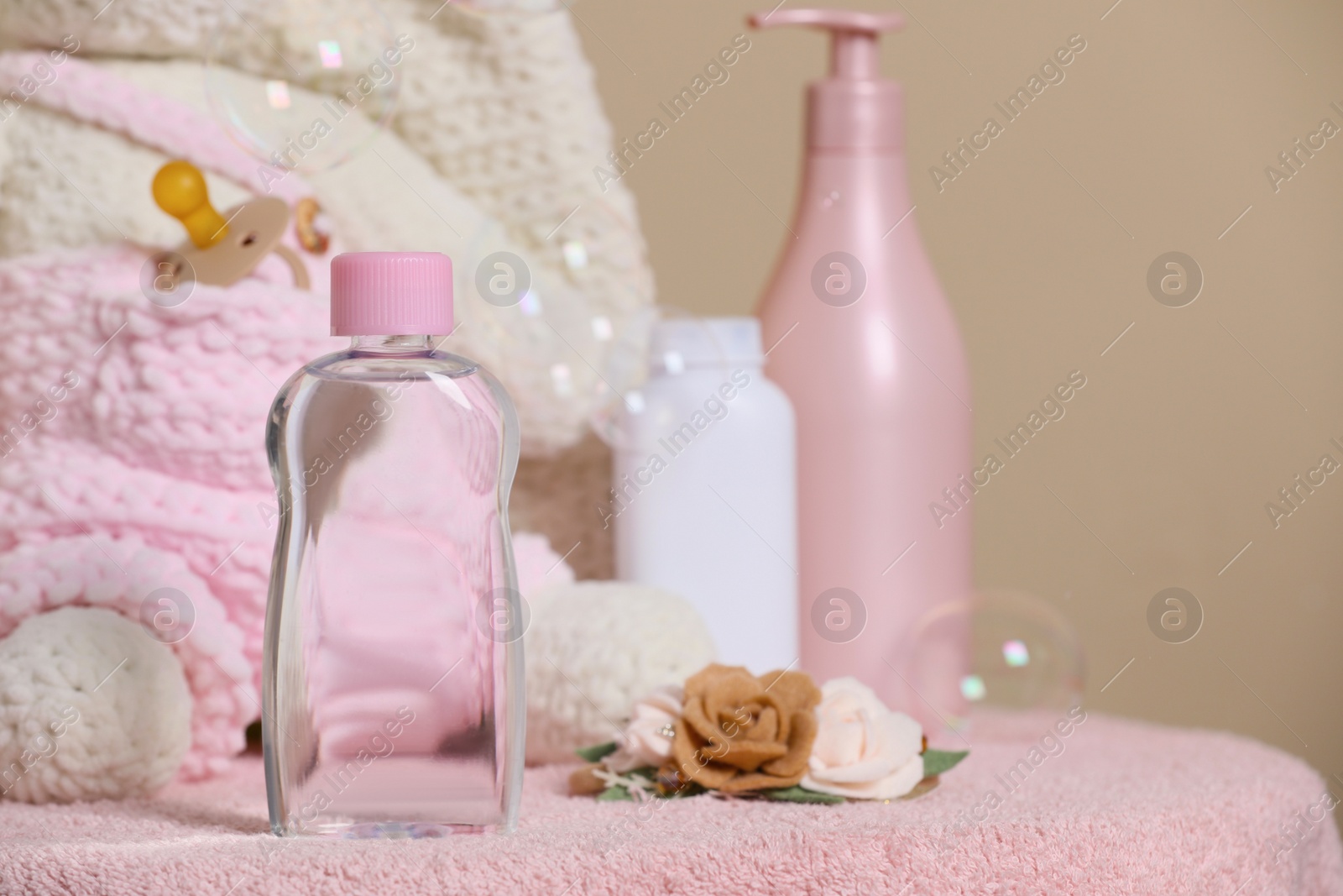 Photo of Baby cosmetic products, accessories and soap bubbles on beige background. Space for text