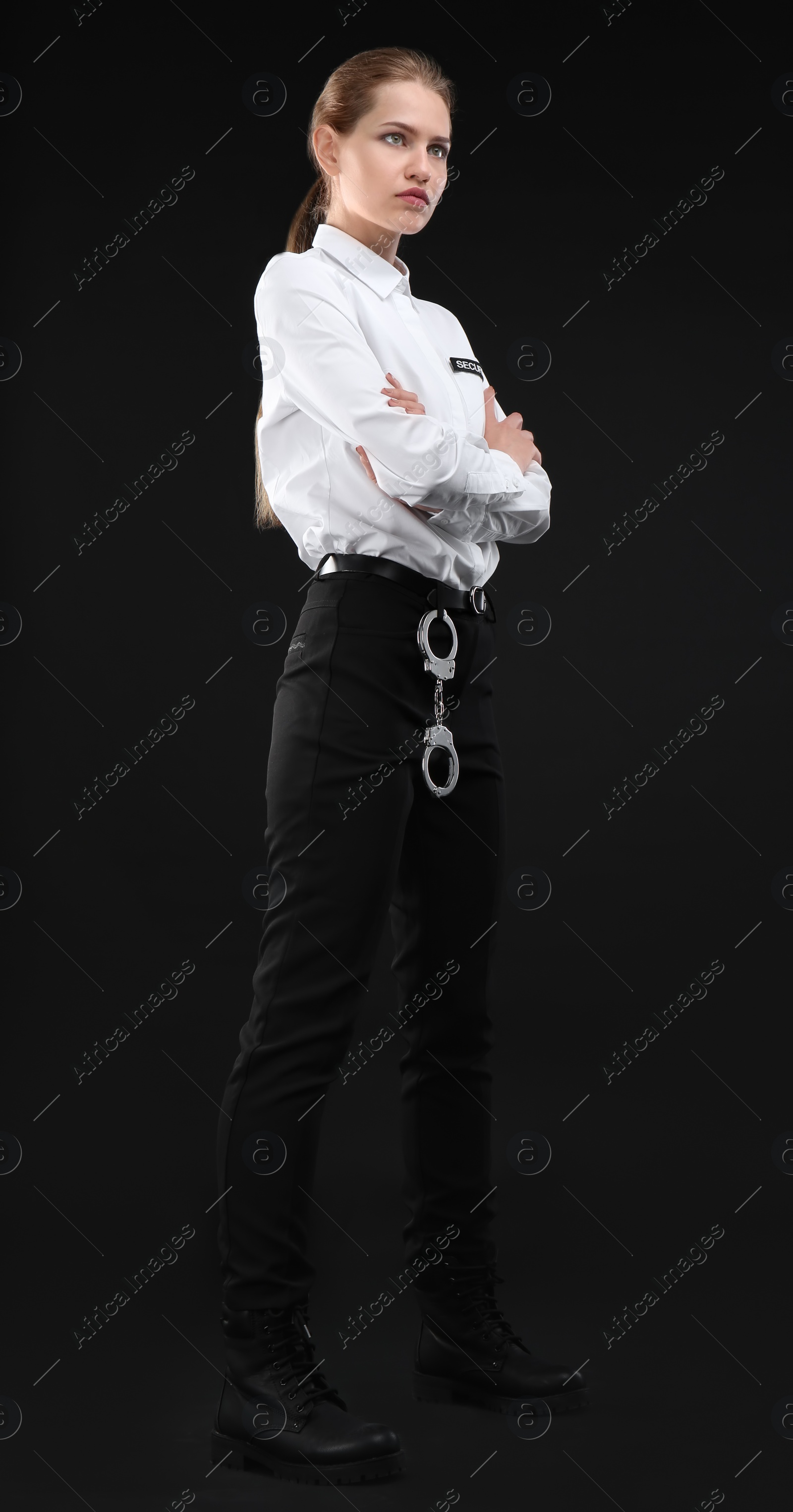 Photo of Female security guard in uniform on dark background