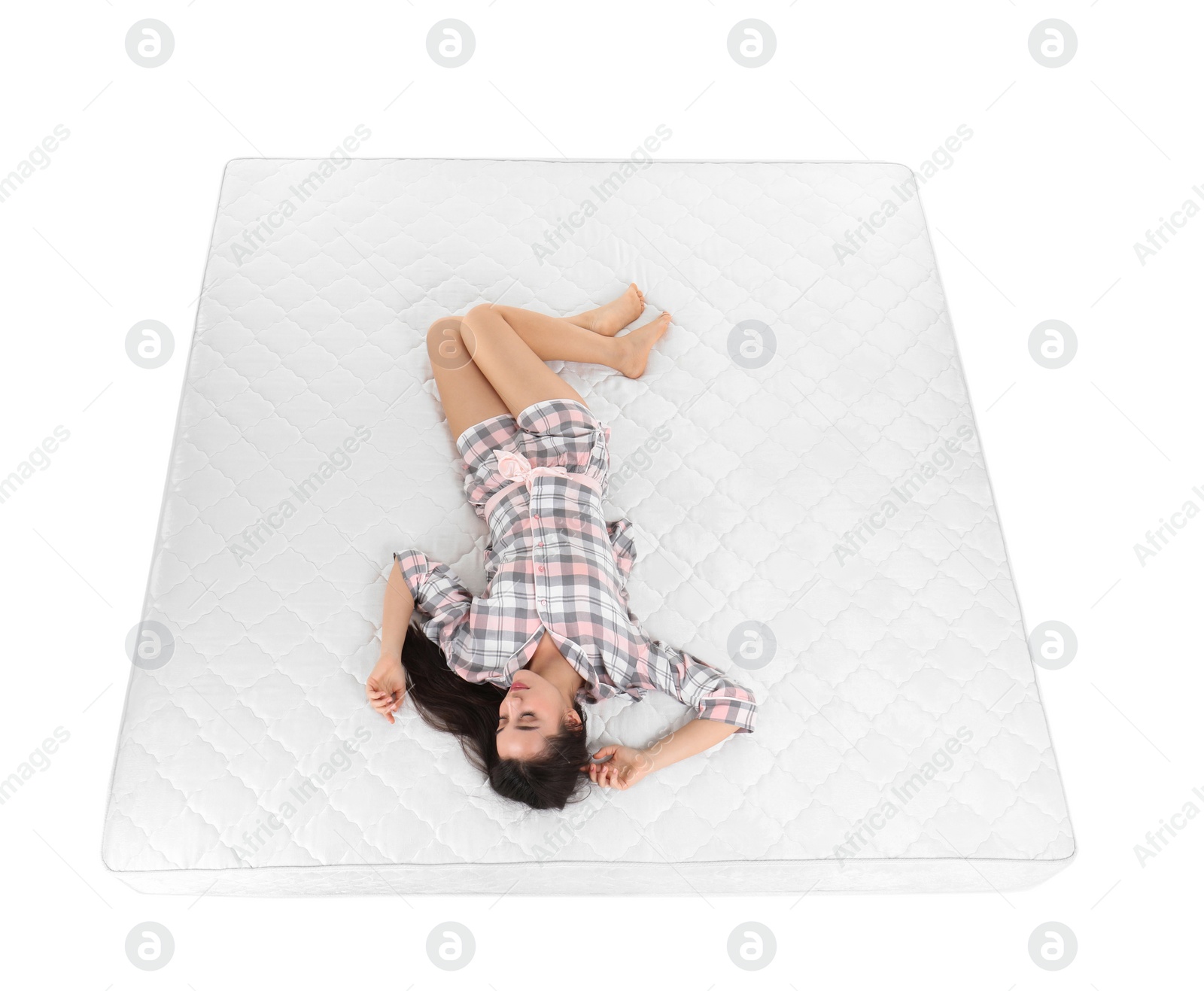 Photo of Young woman sleeping on mattress against white background, above view