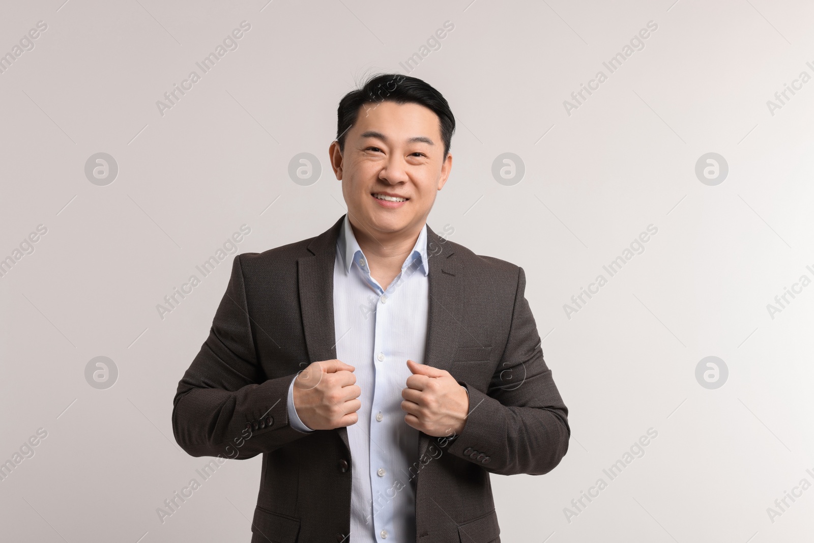 Photo of Portrait of happy man on light background